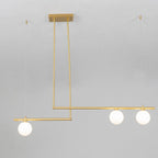 Close view of a three-globe Clérachic gold pendant hanging from its rectangular ceiling plate against a pale wall.