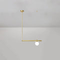 Single-globe Clérachic pendant hung from a round gold ceiling cap, with a gold rod and a short bar, on a pale grey wall.