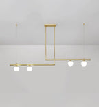 Clérachic gold pendant with four opal globes on two offset bars, hung from a rectangular plate on a pale grey wall.