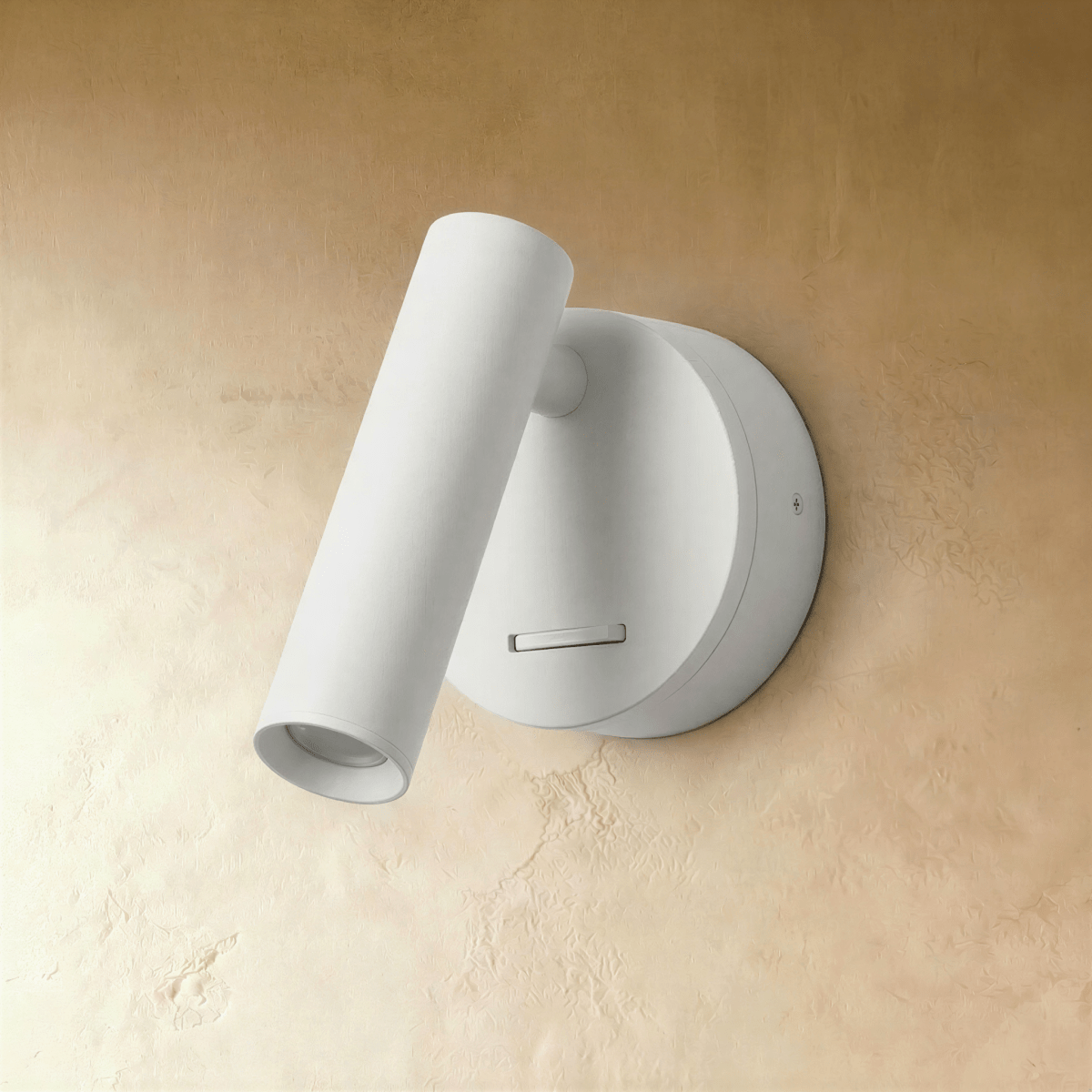 Clérachic matte white wall reading light with a pivoting cylinder head and a small slide switch, shown unlit on a plaster wall.