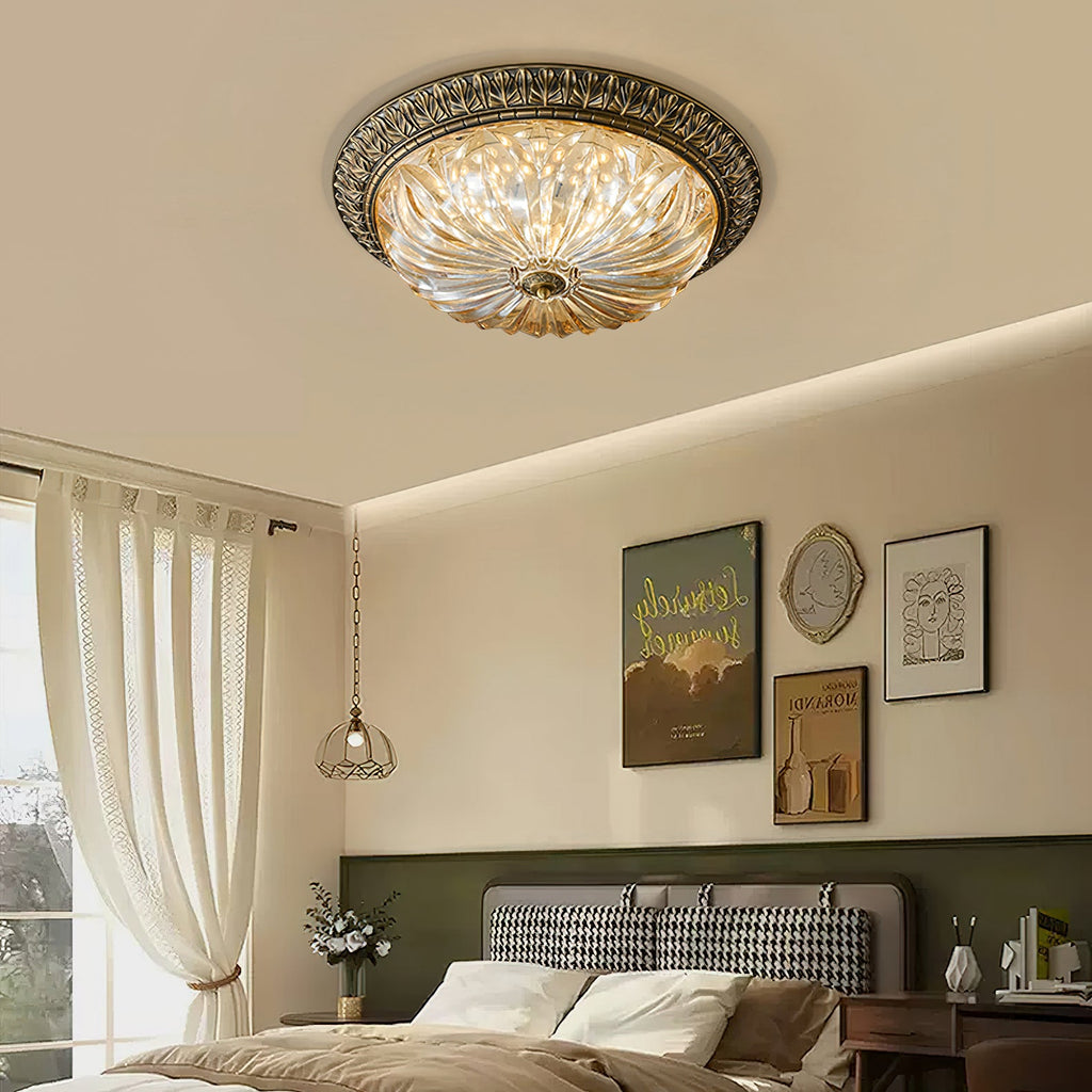 This Clérachic amber glass ceiling light centred above a bedroom with a houndstooth headboard, linen curtains and a pendant light.