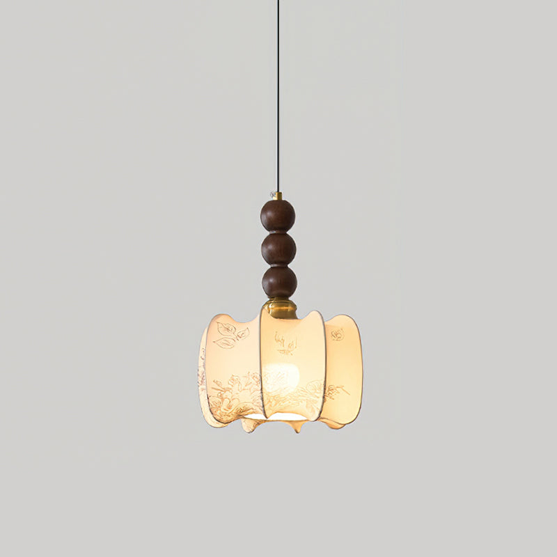 A lit Clérachic pendant with a gathered cream shade and three walnut beads, hung against a light grey backdrop.