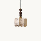 Side view of a Clérachic pendant with a pleated, scalloped cream shade printed with botanical sketches, on a white backdrop.