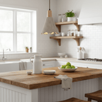 By an open shelf in a white kitchen, a Clérachic pendant hangs near a wooden island holding a bowl of limes.