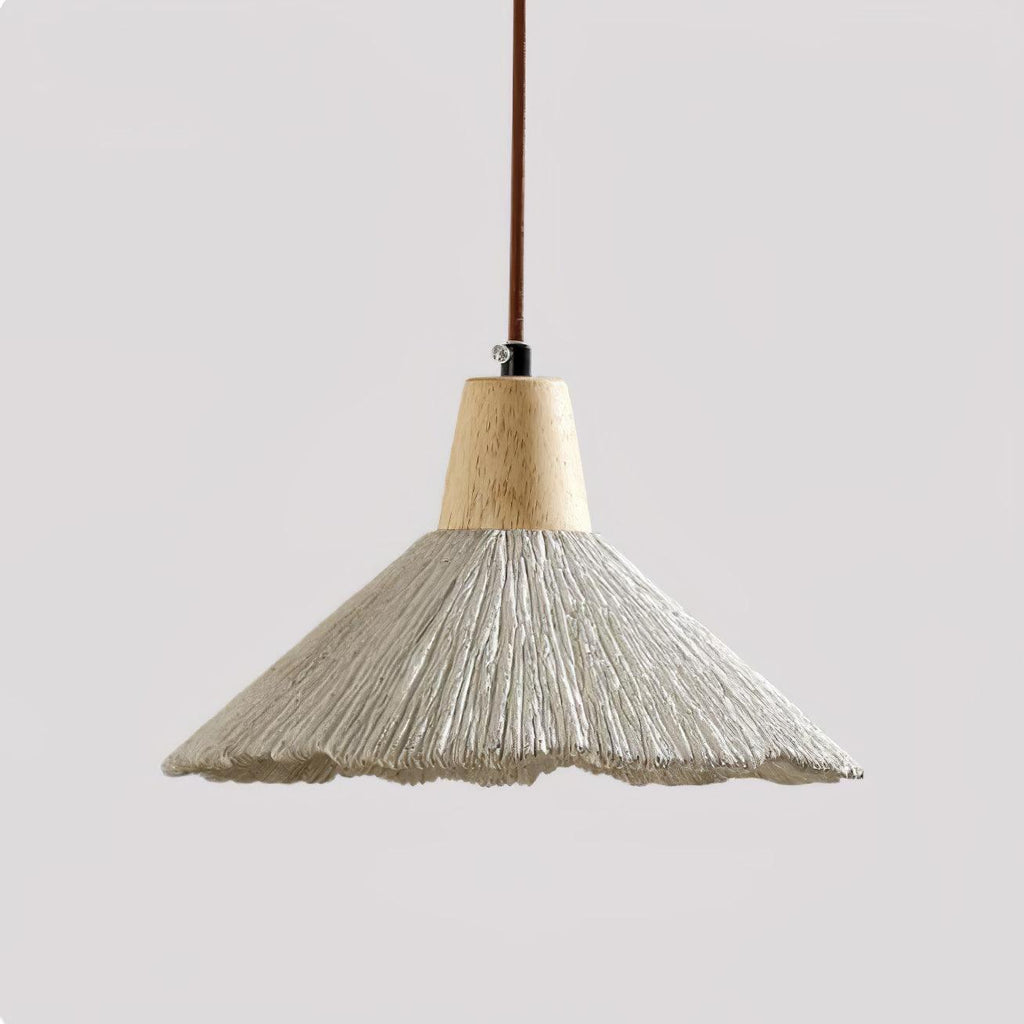 Close view of the wide grey shade on this Clérachic pendant, unlit, with a wavy rim and a ridged surface under a wooden cap.
