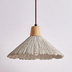 A wide Clérachic pendant seen from slightly below, its scalloped grey rim and ridged shade clear against a soft background.