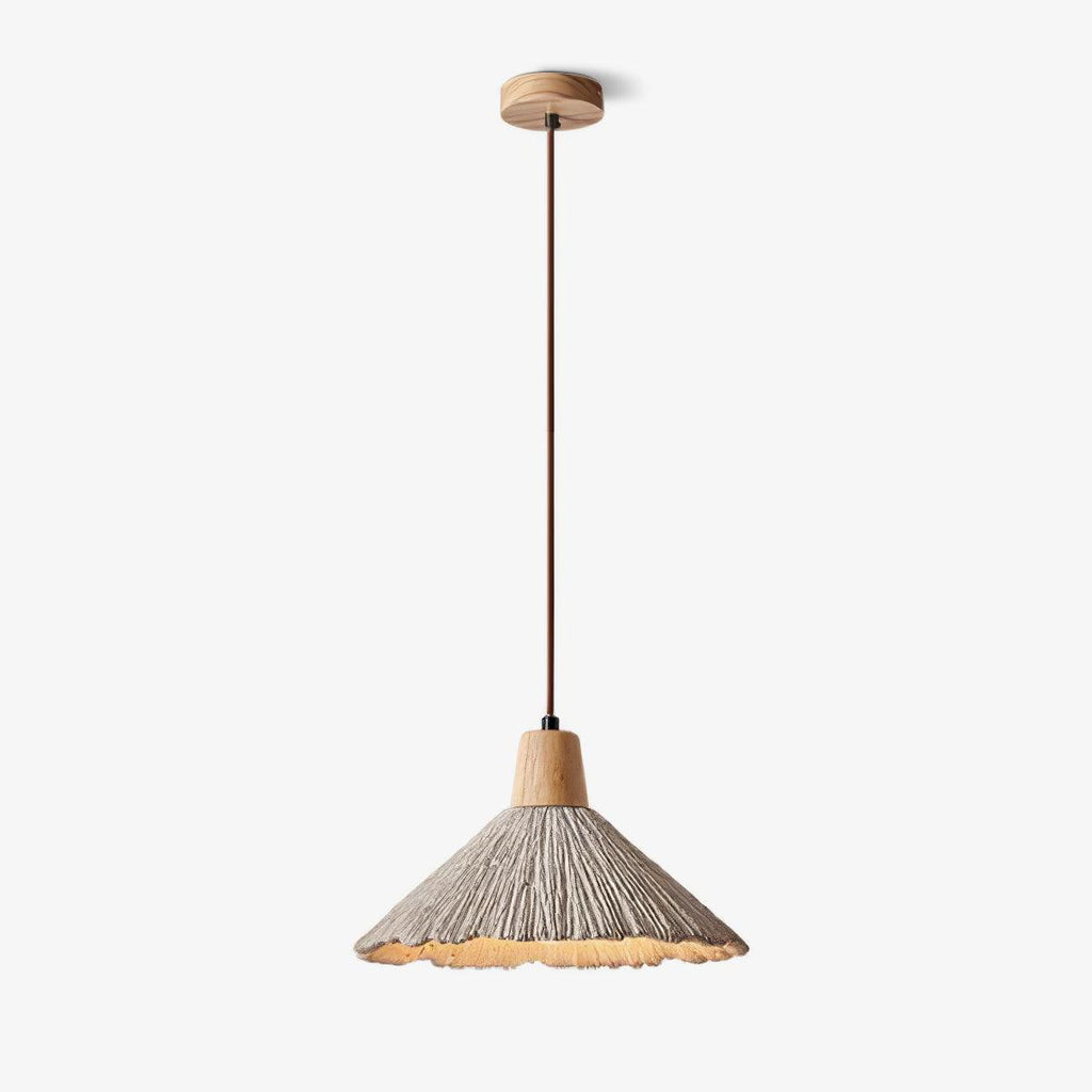 Wide-shade Clérachic pendant with a wooden cap and a brown cord, shown on a plain light backdrop and lit warm underneath.