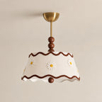 Clérachic ceiling light in a white pleated version with small embroidered daisies, wavy brown trim, wood beads and a brass canopy.