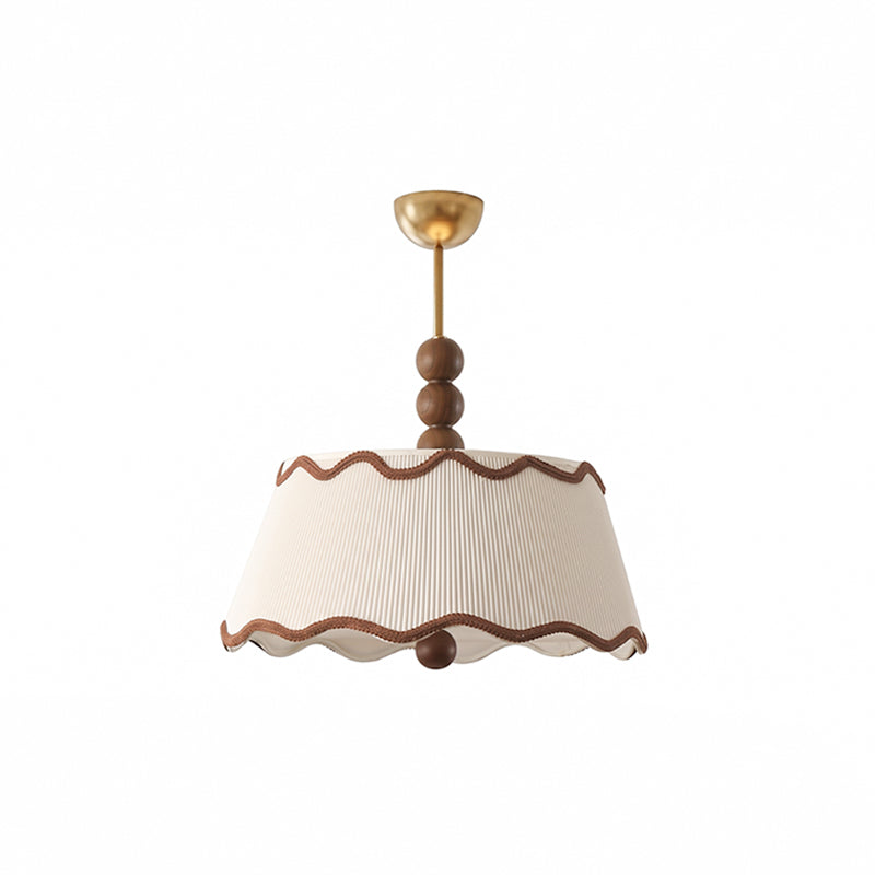 Unlit white pleated Clérachic ceiling light with wavy brown trim, walnut beads and a small brass canopy, on a white backdrop.