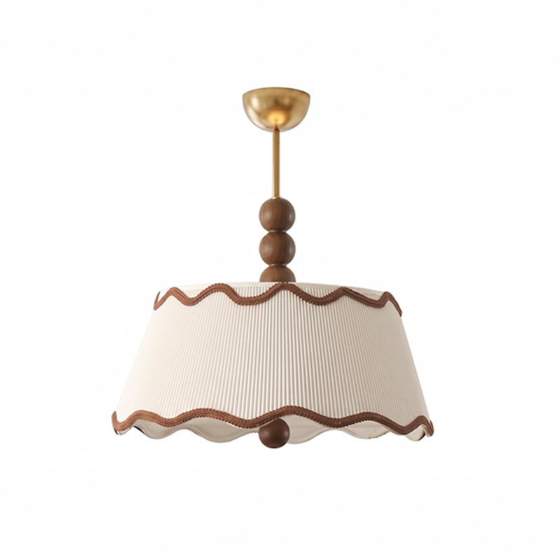 Front view of the white pleated Clérachic ceiling light with a scalloped hem and a wood bead below, on a white backdrop.