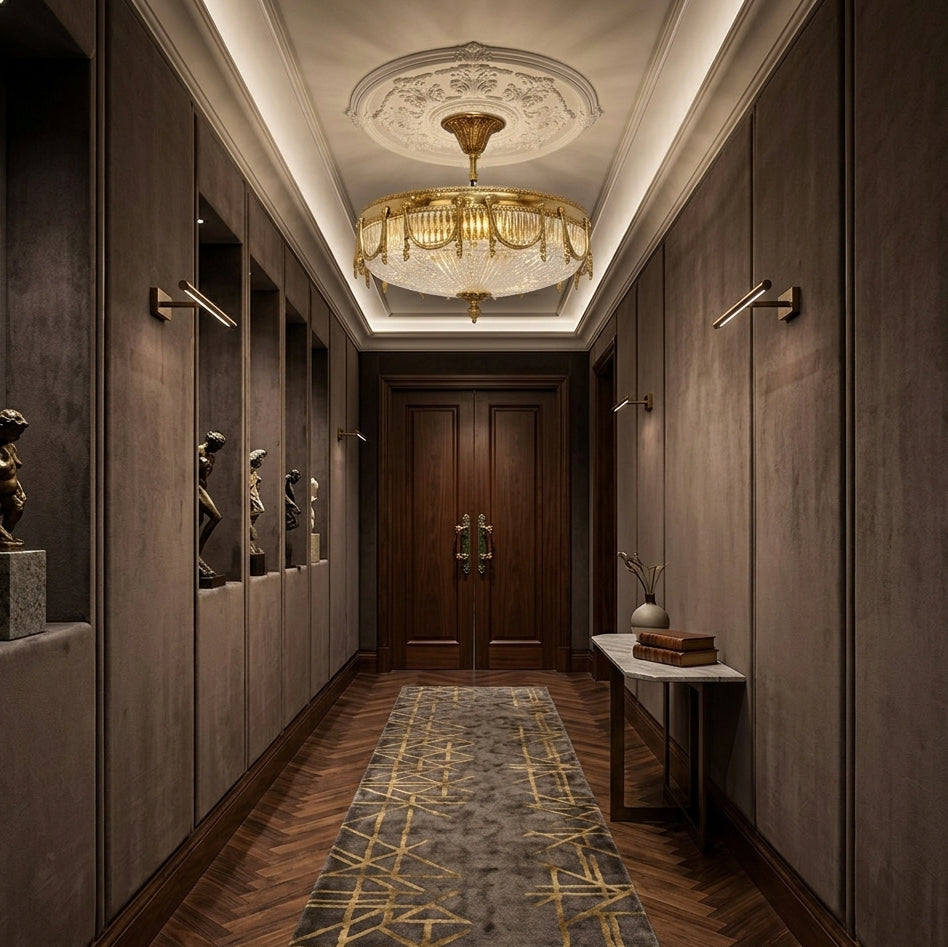Lit Clérachic brass and glass ceiling light at the end of a dark panelled corridor, with a patterned runner on the herringbone floor.