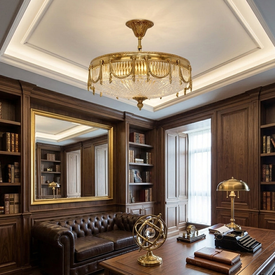 Brass ceiling light with a clear pleated shade, a Clérachic piece, glowing in a wood-panelled study with a leather sofa and desk.