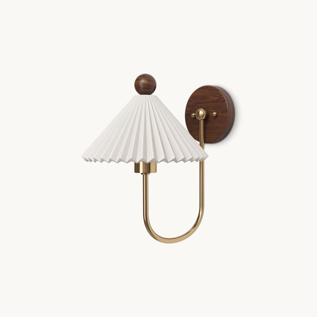 This Clérachic wall lamp on a plain white backdrop, with a pleated white shade, a round walnut ball finial and a curved brass arm.