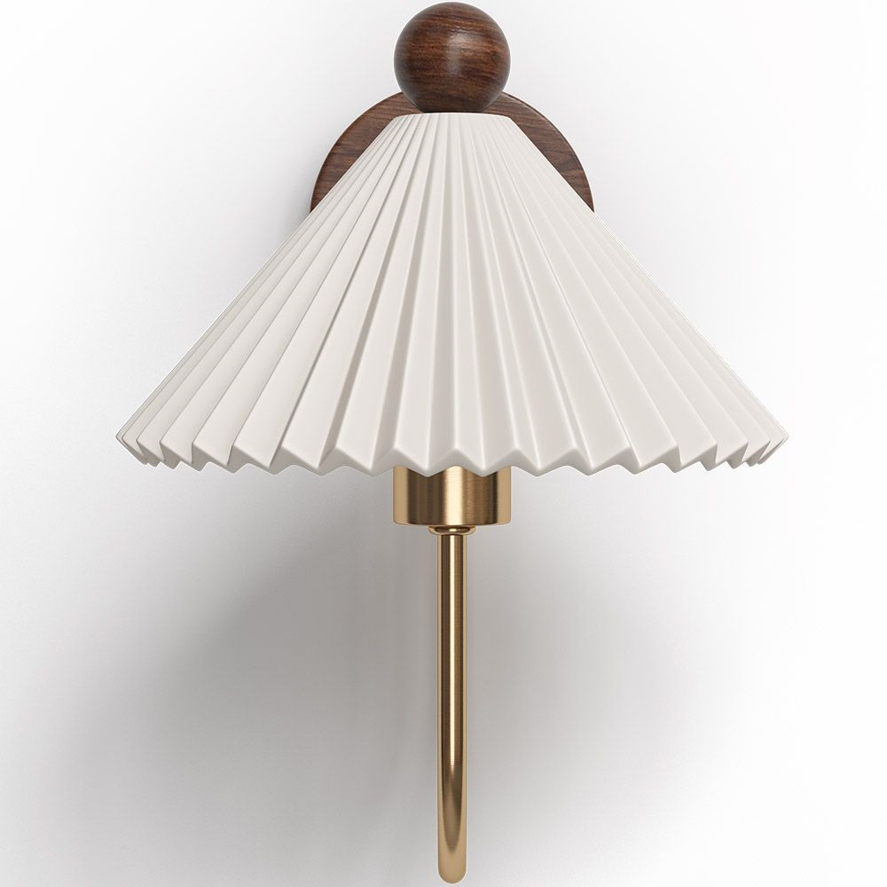 Close view of the pleated white shade and walnut ball finial on this Clérachic wall lamp, with the brass arm curving down below it.