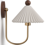 Side view of a Clérachic wall lamp, with a pleated white shade on a deep U-shaped brass arm and a round wooden backplate.