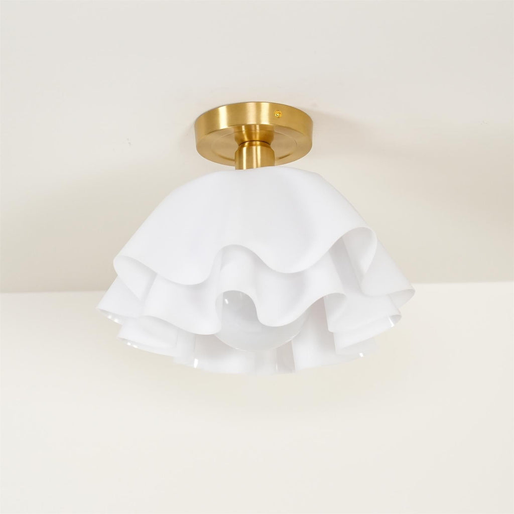 Clérachic Pleated Petal Ceiling Light fitted to a cream ceiling, the brushed brass canopy plate and its fixing screw in clear view.