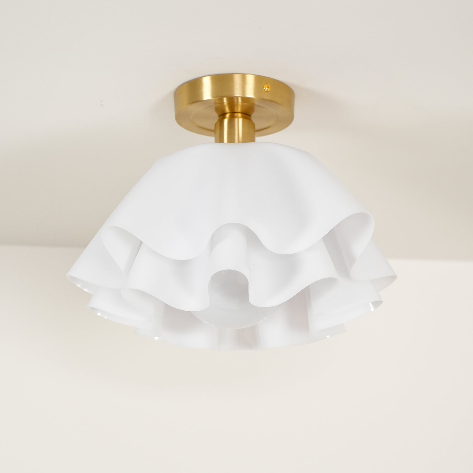 The Clérachic Pleated Petal Ceiling Light unlit, showing the chalk-white matte petals and the scalloped gaps between each layer.