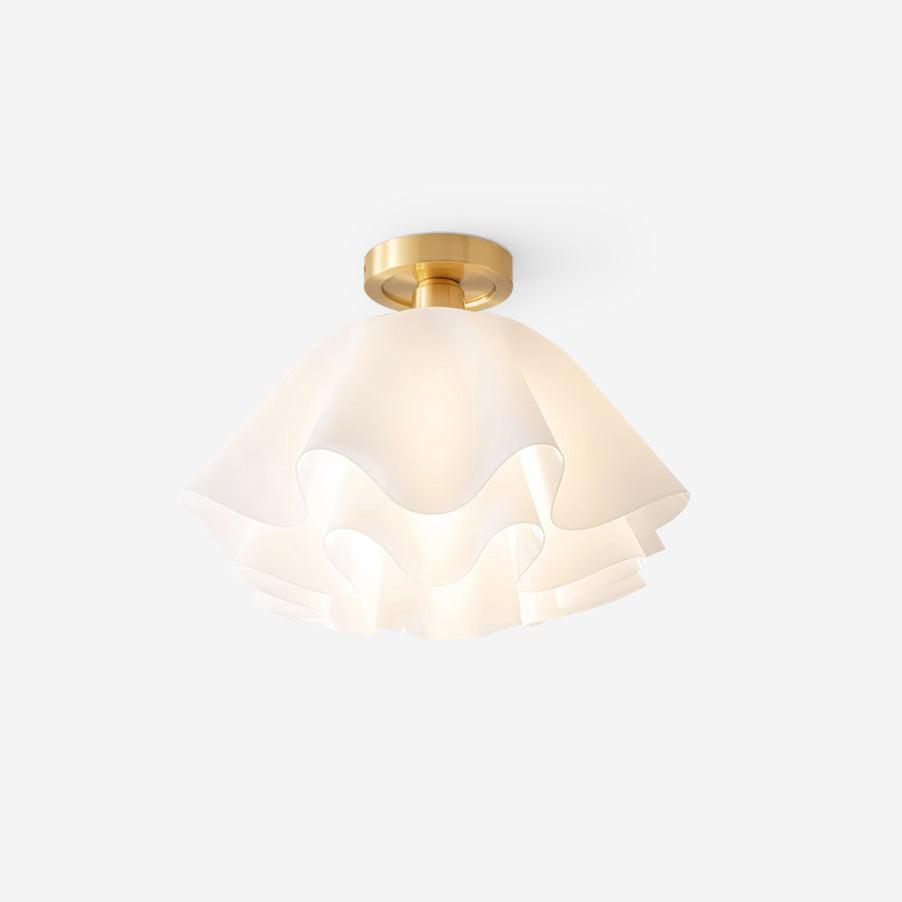 Angled studio shot of the Clérachic Pleated Petal Ceiling Light against white, the brass collar carrying the shade close to the ceiling.