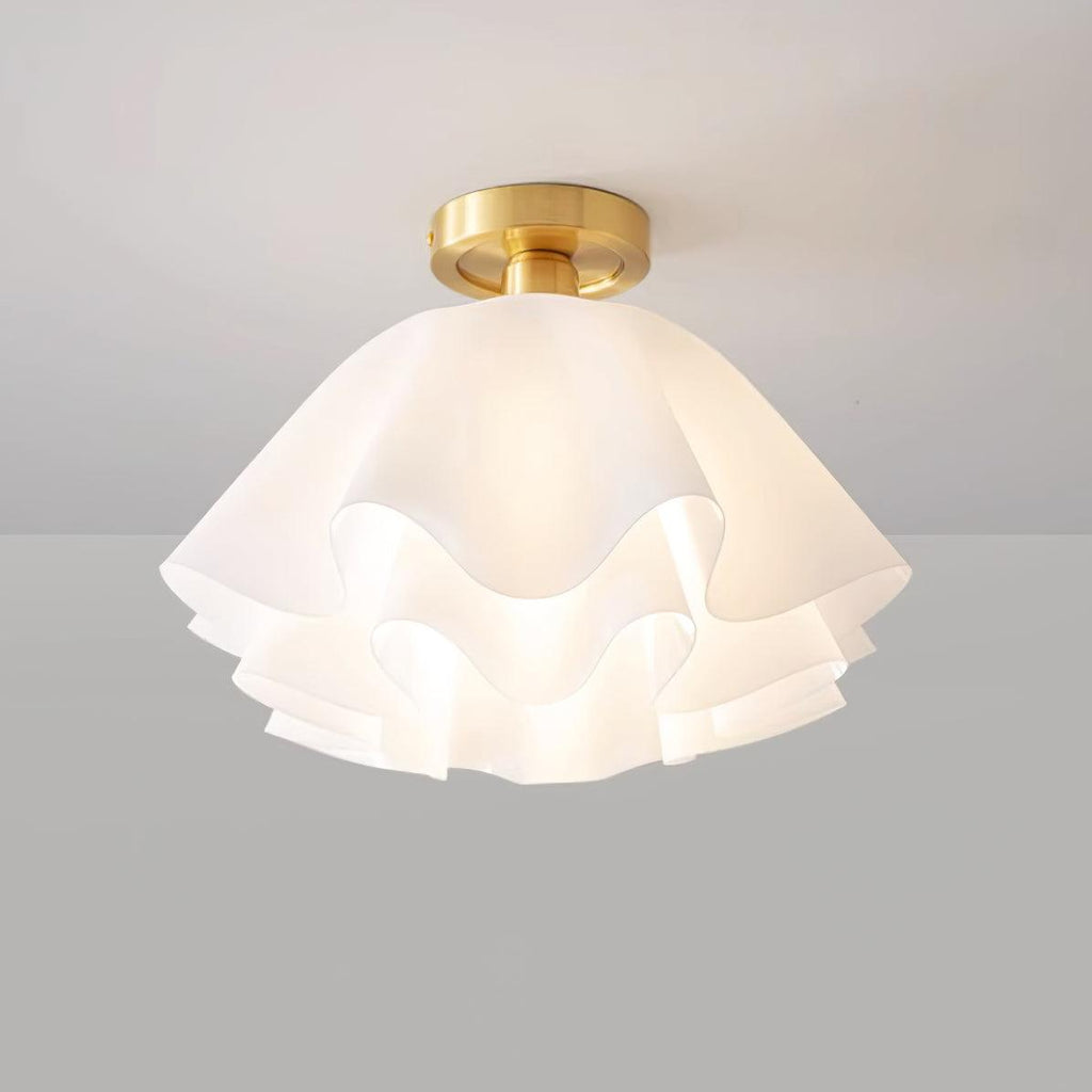 Straight-on studio view of the Clérachic Pleated Petal Ceiling Light lit, the bulb glowing softly through the top layer of petals.