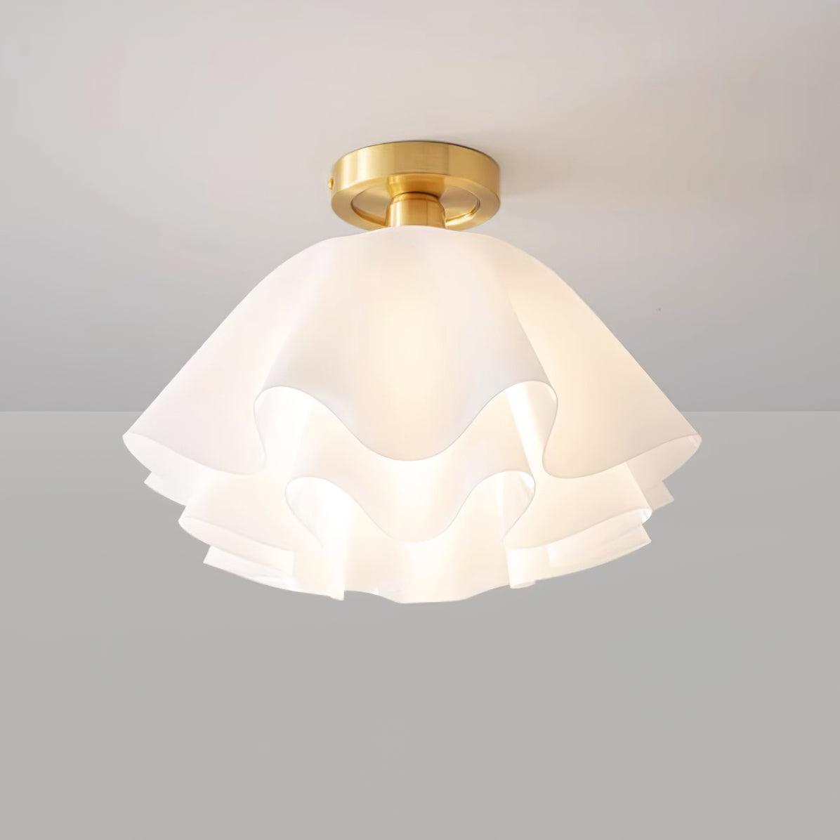 Straight-on studio view of the Clérachic Pleated Petal Ceiling Light lit, the bulb glowing softly through the top layer of petals.