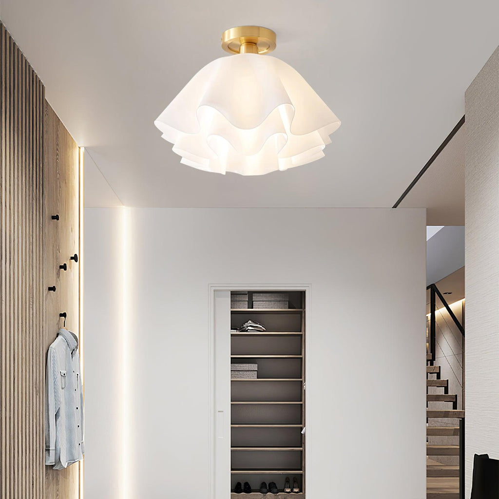 In an entrance hall with a slatted oak wall and coat hooks, the Clérachic Pleated Petal Ceiling Light fills the ceiling with warm light.