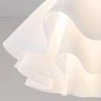 Detail crop of the Clérachic Pleated Petal Ceiling Light, light escaping through the scalloped gaps between the acrylic folds.