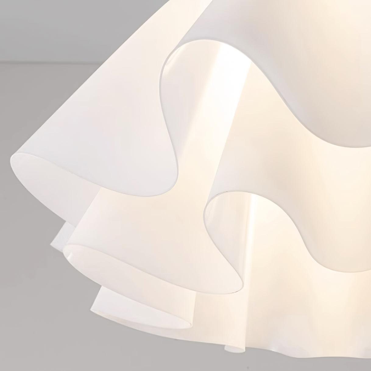 Detail crop of the Clérachic Pleated Petal Ceiling Light, light escaping through the scalloped gaps between the acrylic folds.