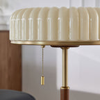 Close view of the ribbed glass shade, gold rim and beaded pull chain on this Clérachic table lamp.