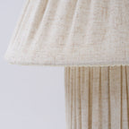 Close view of the shade's scalloped hem and the vertical pleats on the base of this Clérachic lamp.