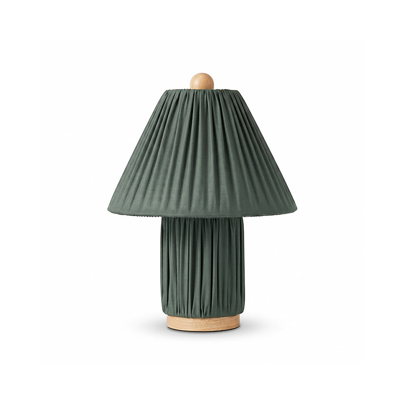 Dark green pleated table lamp from Clérachic with a wooden ball finial and a wooden foot, on a white backdrop.