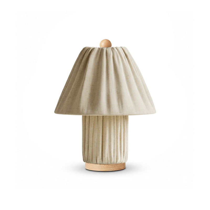 A sand-coloured version of this Clérachic pleated lamp, with a wooden finial and foot, on a white backdrop.