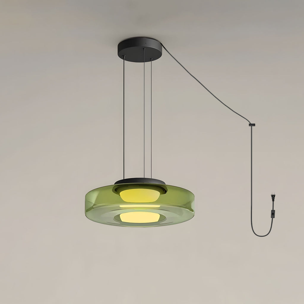 A single tier of green glass forms this Clérachic pendant, cord and plug visible against a plain backdrop.