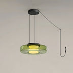 A single tier of green glass forms this Clérachic pendant, cord and plug visible against a plain backdrop.
