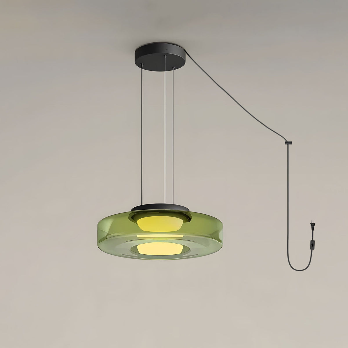 A single tier of green glass forms this Clérachic pendant, cord and plug visible against a plain backdrop.