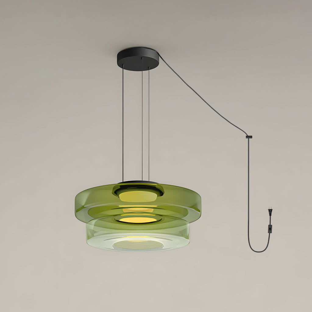 Two tiers of green glass stack on this Clérachic pendant against a plain grey backdrop.