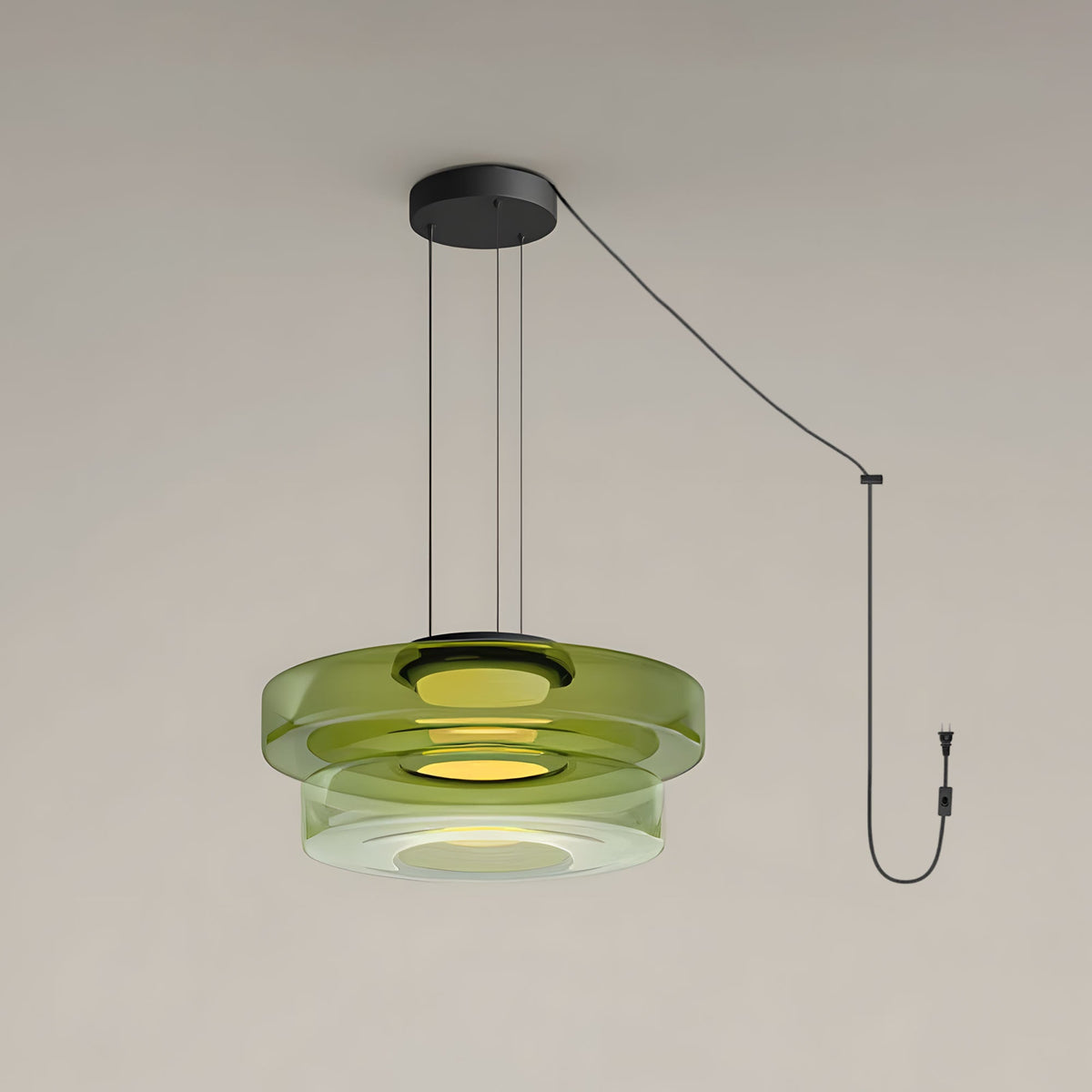 Two tiers of green glass stack on this Clérachic pendant against a plain grey backdrop.