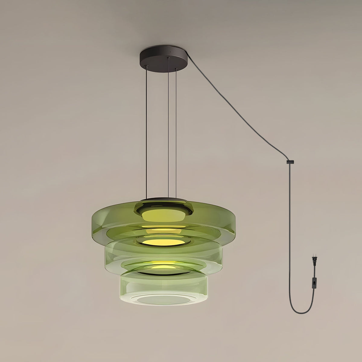 Three tiers of green glass stack on this Clérachic pendant, shown with its cord and plug.