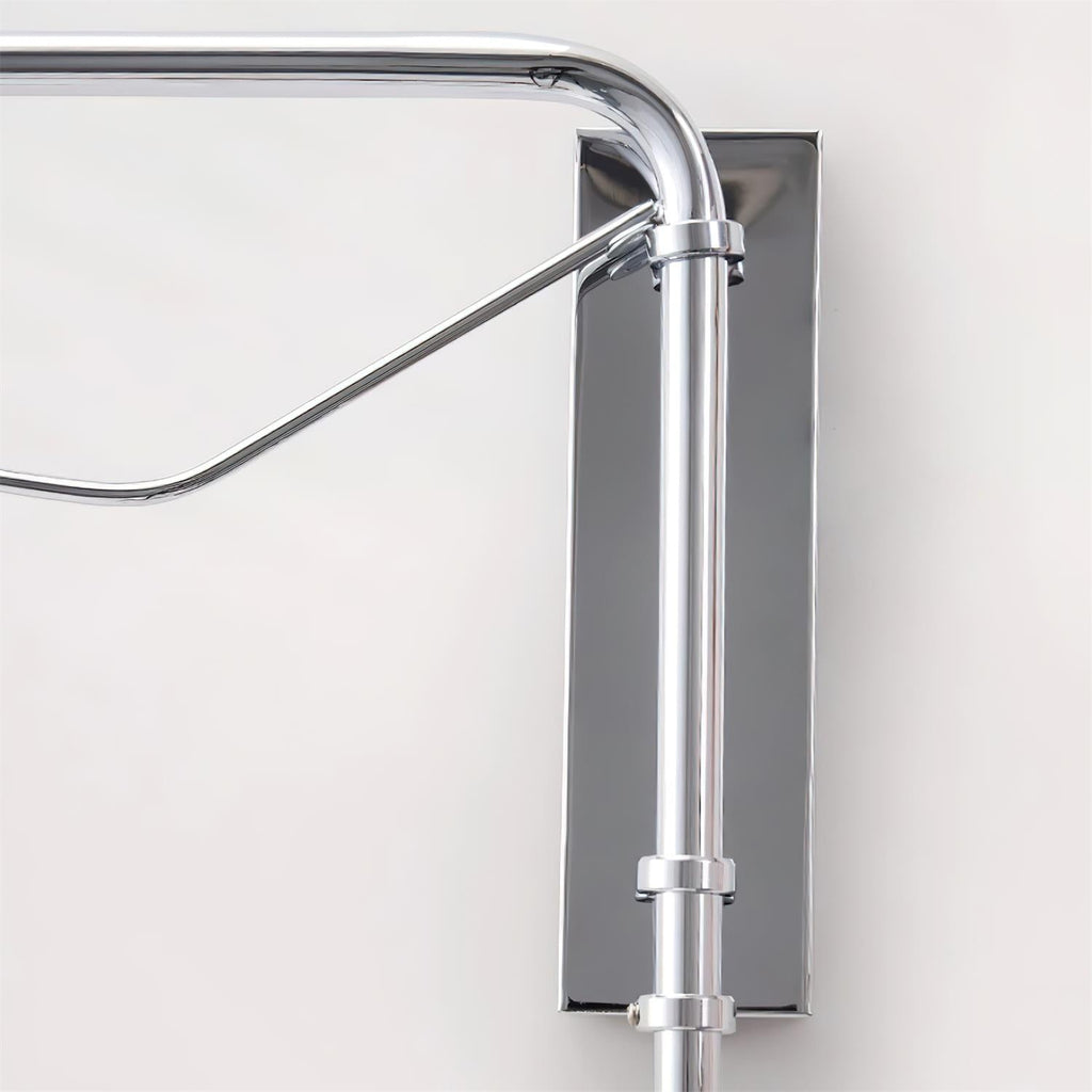 Close view of the chrome wall plate, joint and diagonal brace where the arm of this Clérachic wall light meets the wall.