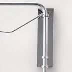 Close view of the chrome wall plate, joint and diagonal brace where the arm of this Clérachic wall light meets the wall.