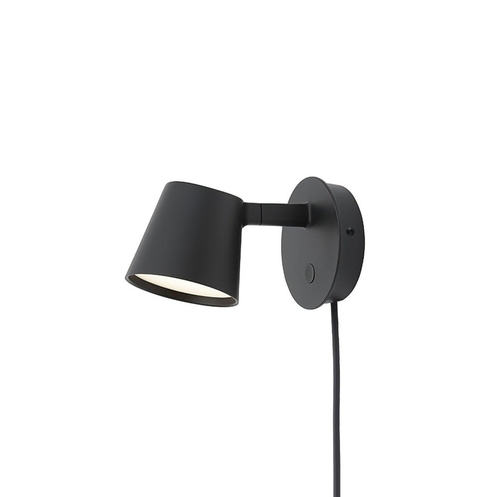 Black Clérachic wall light on a white background, its shade tilted forward and its cord hanging below.