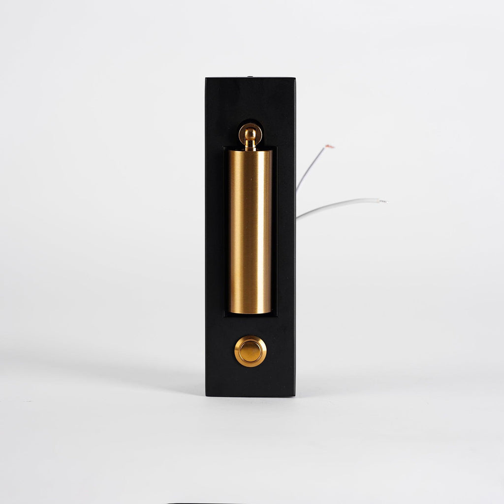 Front view of this Clérachic wall light with its brass-coloured head folded flat in the recess and loose wires at the side.