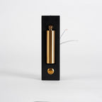 Front view of this Clérachic wall light with its brass-coloured head folded flat in the recess and loose wires at the side.