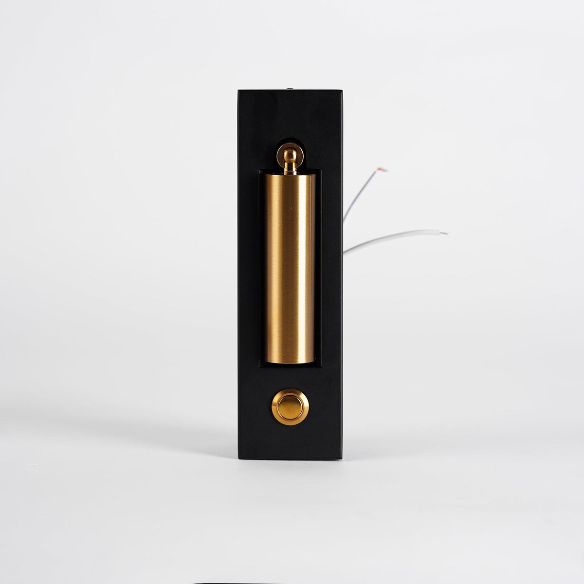 Front view of this Clérachic wall light with its brass-coloured head folded flat in the recess and loose wires at the side.