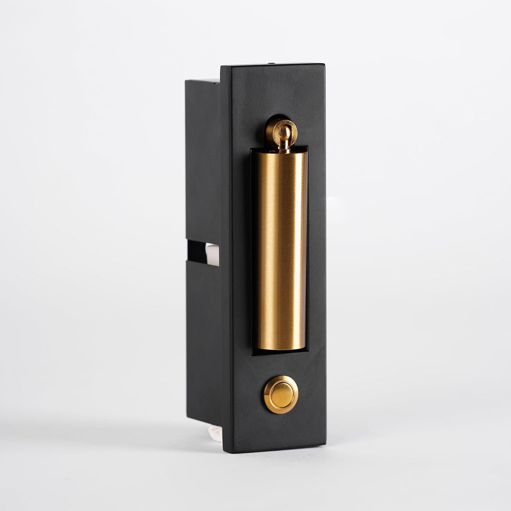 Side view of this Clérachic wall light, its brass-coloured head folded in and a round button on the black plate.