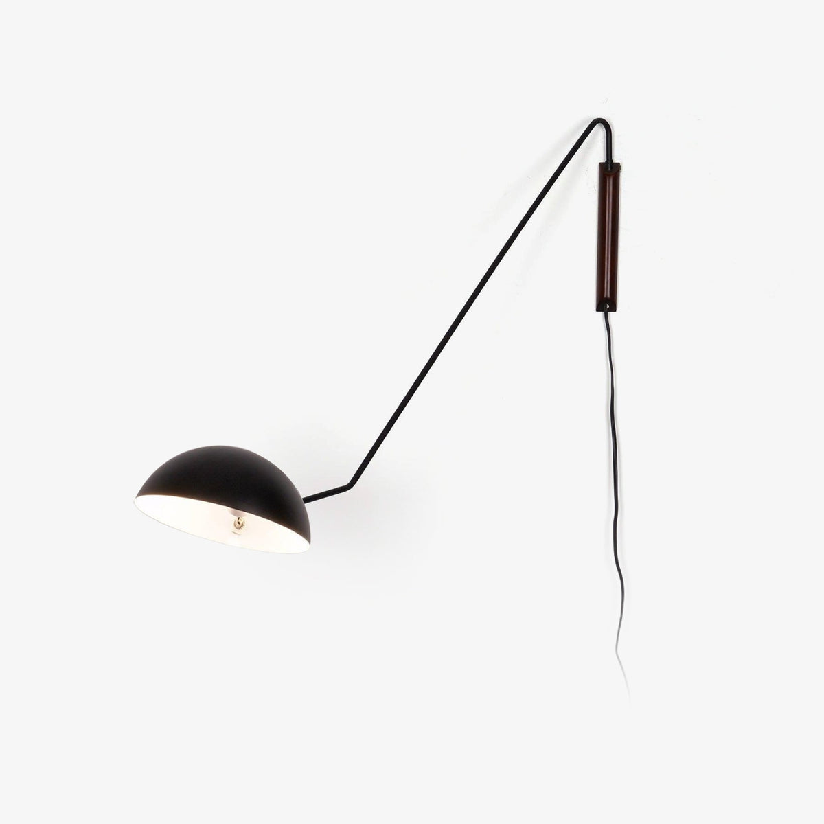 Black Clérachic wall light with a walnut plate and a white inner shade, with its cord trailing, on a plain white background.