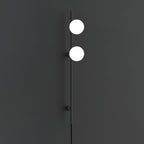 This Clérachic wall light on a charcoal wall, with two bright white globes on a slim black rod and a cord below.