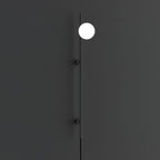 A single bright globe on the slim black rod of this Clérachic wall light, against a dark charcoal wall with two small mounts.