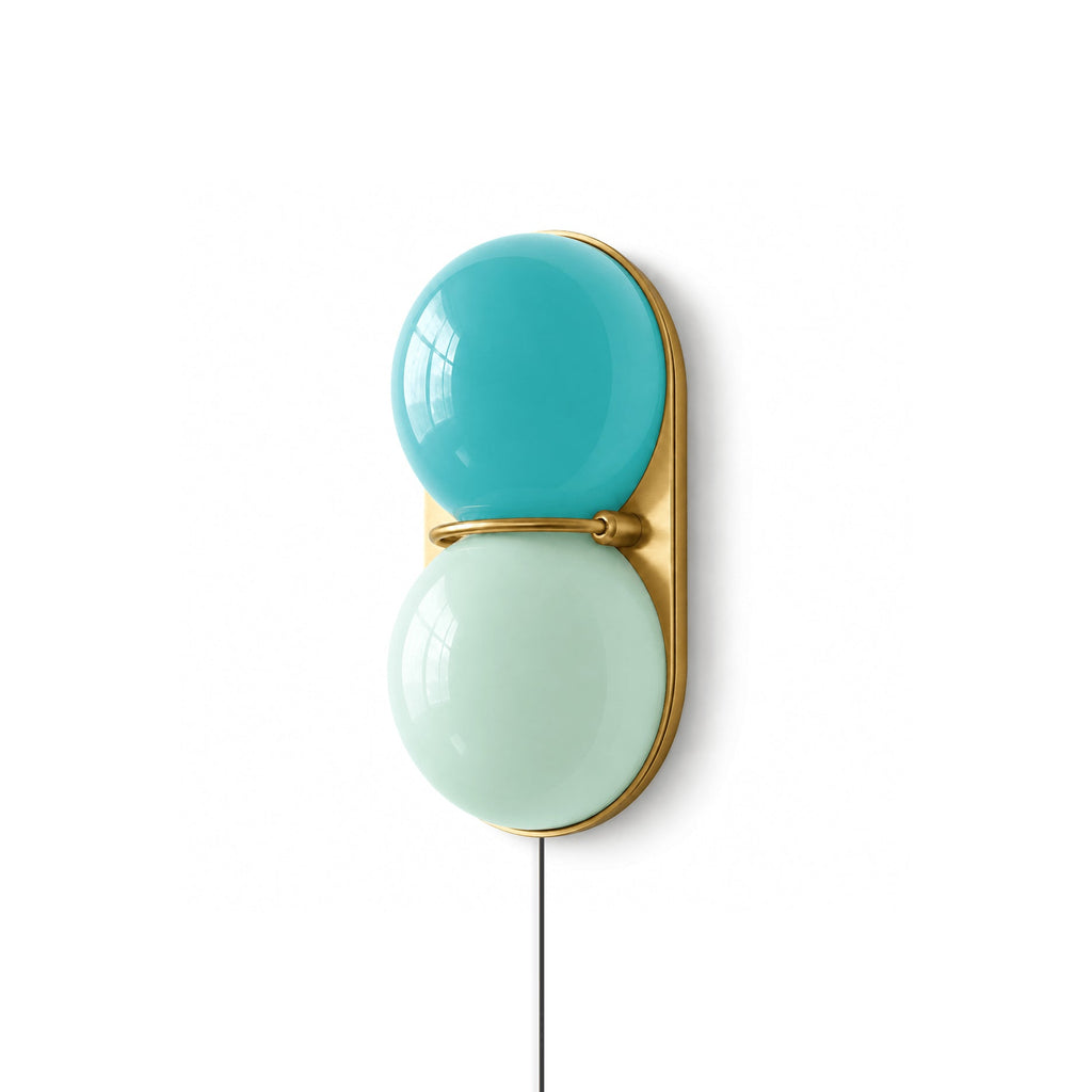 Clérachic two-globe wall sconce with a bright blue globe above a mint one on a brass oval backplate and a white background.