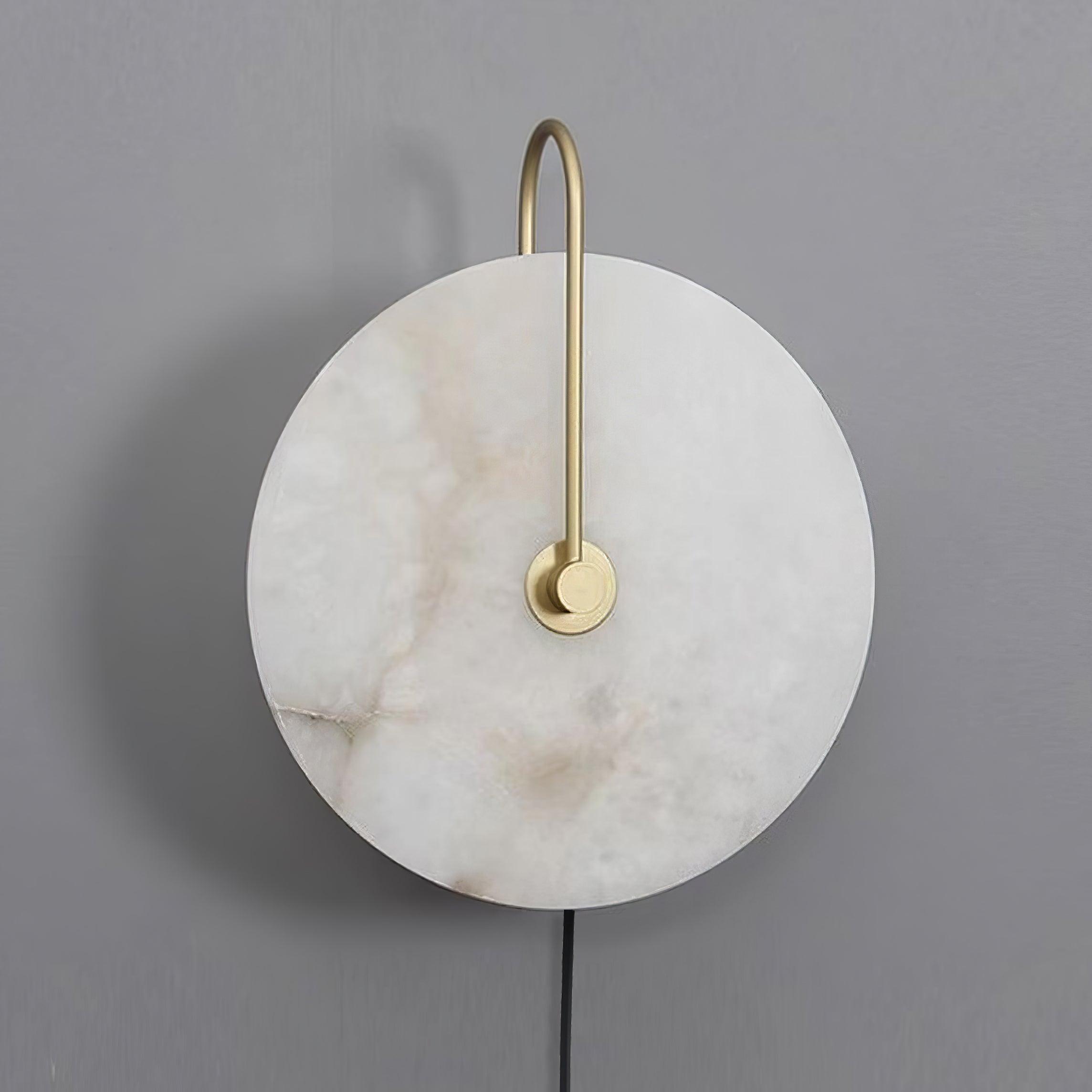 Clérachic Plug-In Wall Sconce switched off on a grey wall, warm brown veining running through the alabaster globe shade.