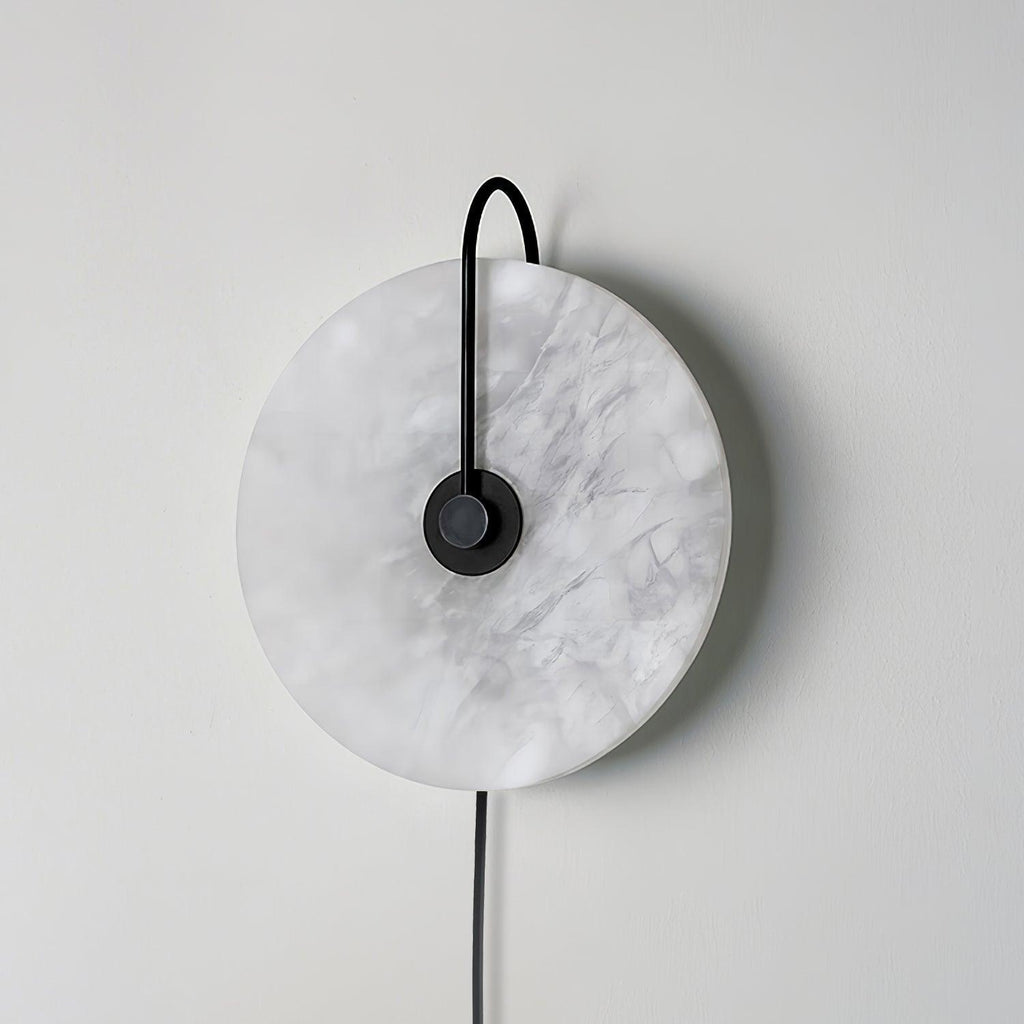 Clérachic Plug-In Wall Sconce in the black finish, switched off, with grey veining across the unlit stone disc.